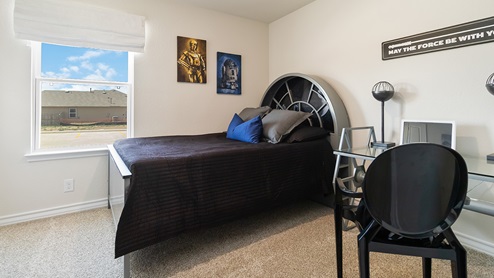 secondary bedroom with large windows and quality carpet flooring