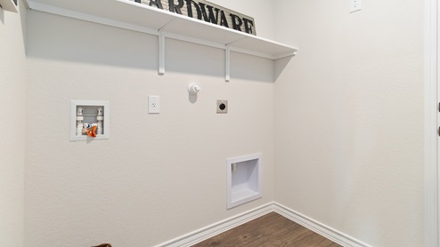 utility room with hard surface flooring and built in shelving