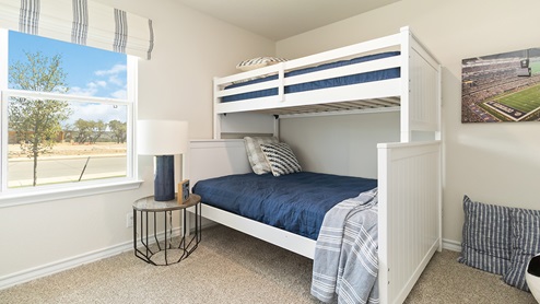 secondary bedroom with large windows and quality carpet flooring