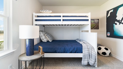 secondary bedroom with large windows and quality carpet flooring