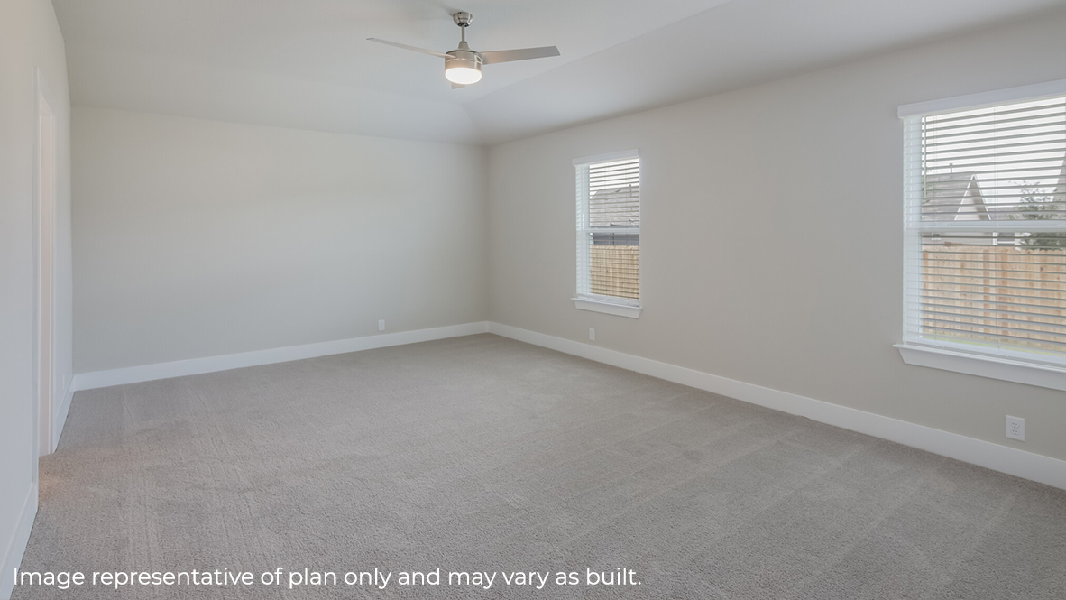 primary bedroom with ceiling fan, large windows and quality carpet flooring.
