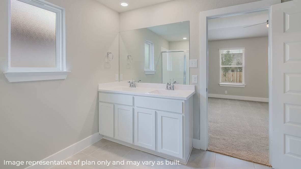 primary bathroom with dual vanity sinks.
