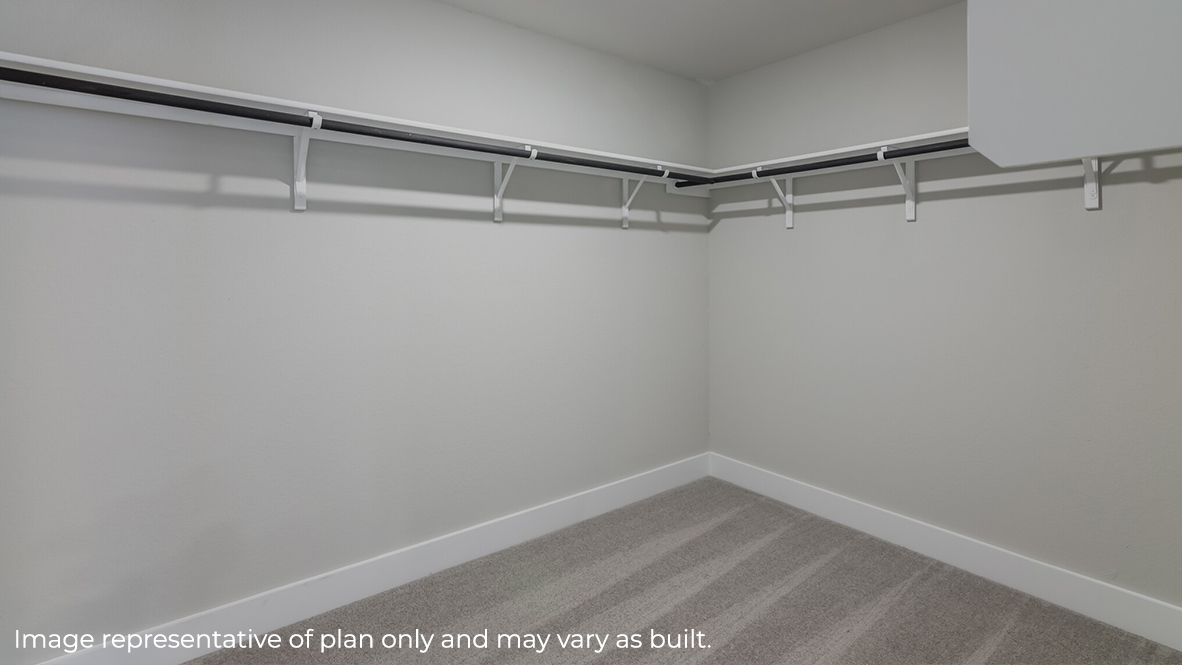 Spacious walk-in closet off of primary bathroom.