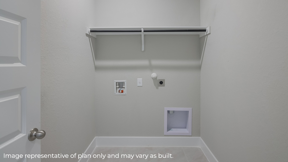 utility room with hard surface flooring, washer and dryer connections and built in shelving.