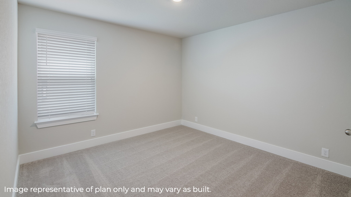 second bedroom with carpet and large window.