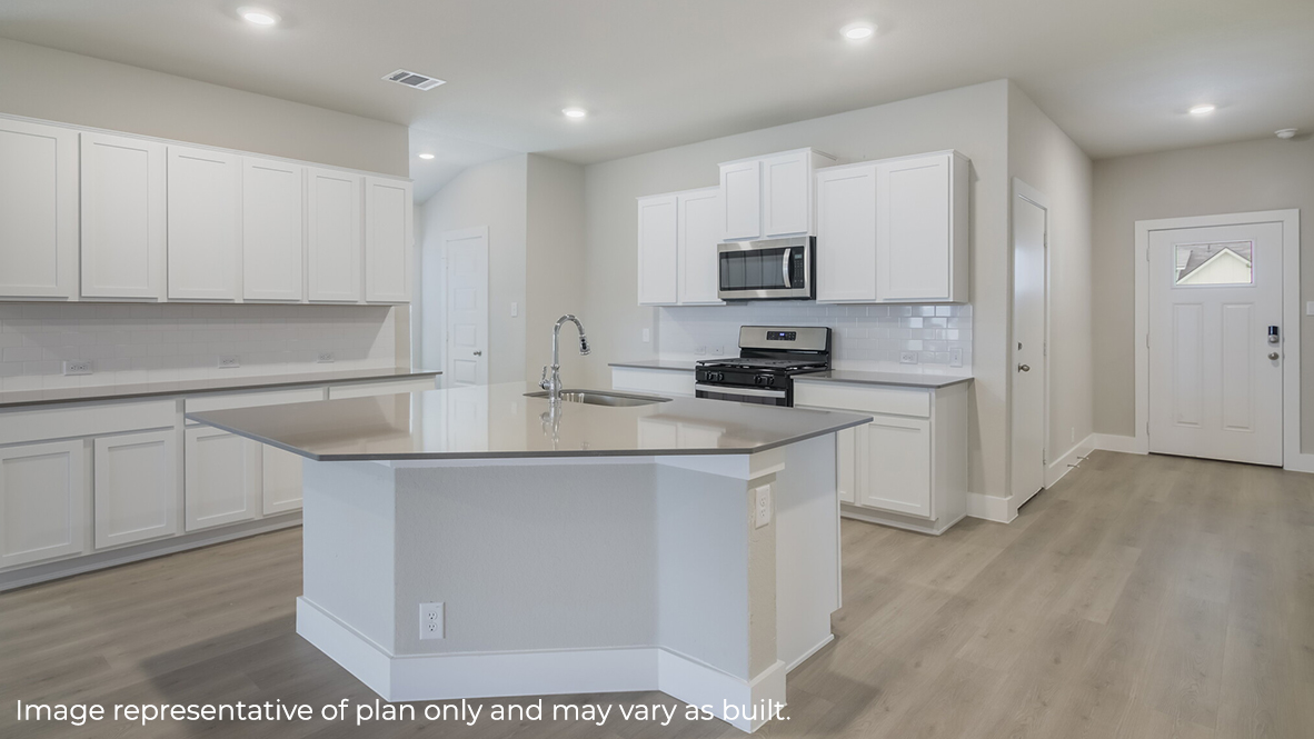 kitchen with quartz countertops, subway tile backsplash, stainless steel appliances and elongated kitchen island.