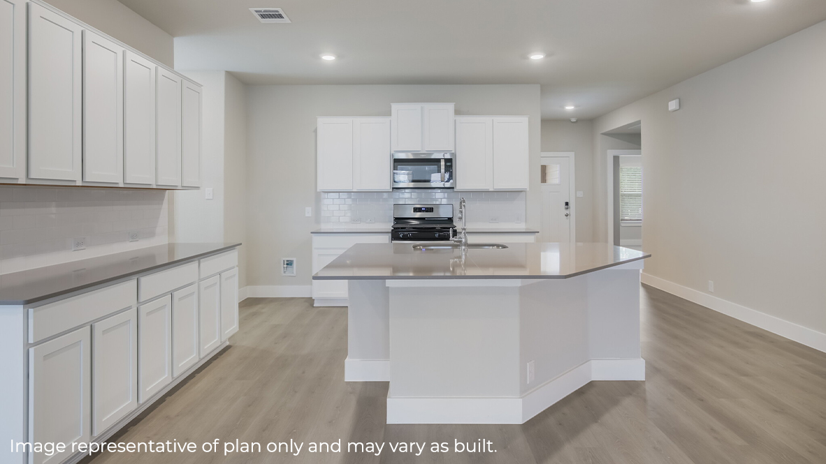 kitchen with quartz countertops, subway tile backsplash, stainless steel appliances and elongated kitchen island.