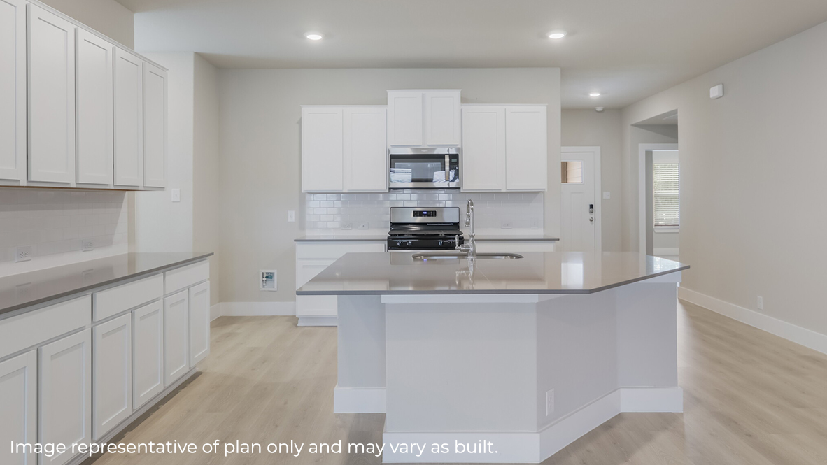 kitchen with quartz countertops, subway tile backsplash, stainless steel appliances and elongated kitchen island.