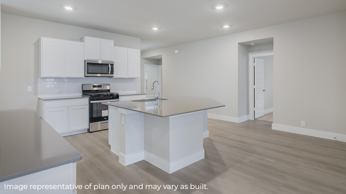 kitchen with quartz countertops, stainless steel appliances and spacious kitchen island with a deep, single basin sink.