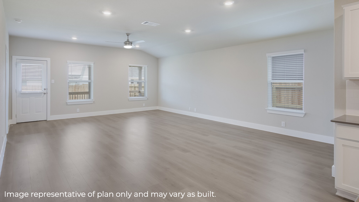 blended dining area and living room with hard surface flooring, large windows and ceiling fan.