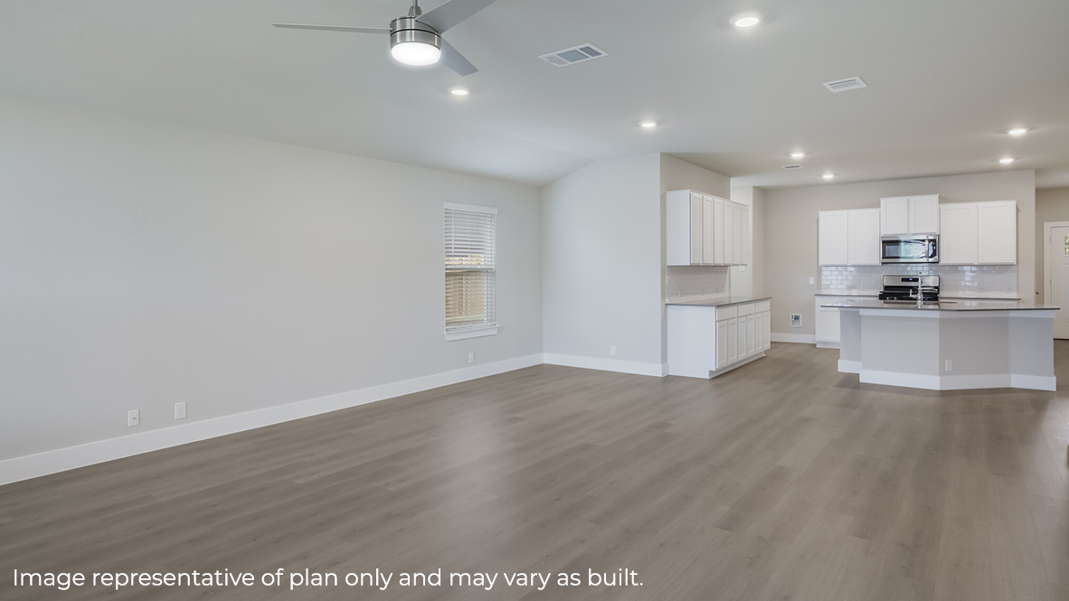 living room with hard surface flooring flowing into open concept dining area and kitchen.