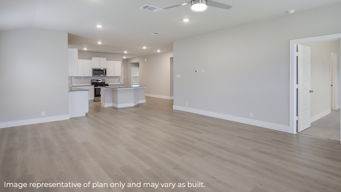 living room with hard surface flooring flowing into open concept dining area and kitchen.