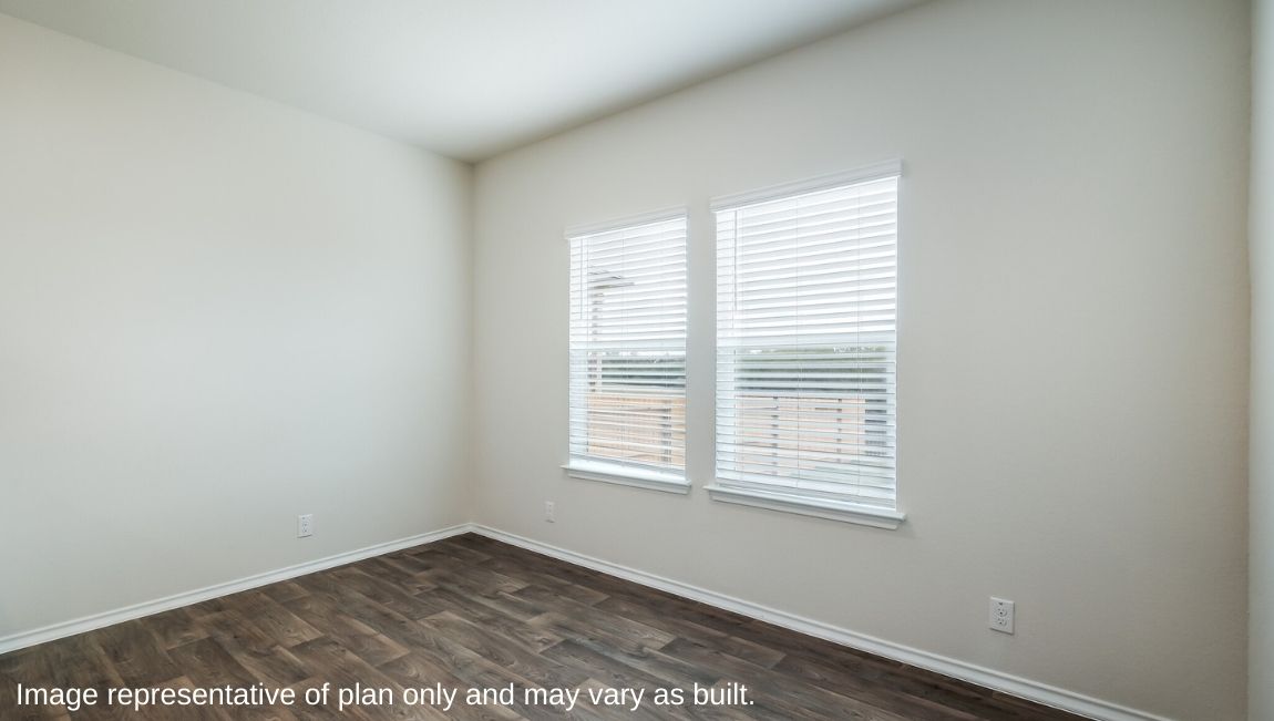 Dining area with window, overlooking kitchen and living area.