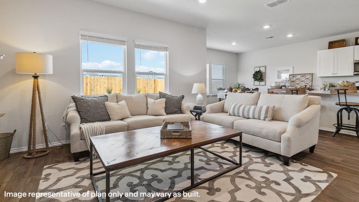Open-concept living area with hard surface flooring and windows providing plenty of natural light.