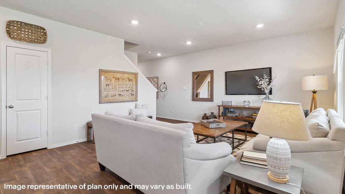 Open-concept living area with hard surface flooring and windows providing plenty of natural light.