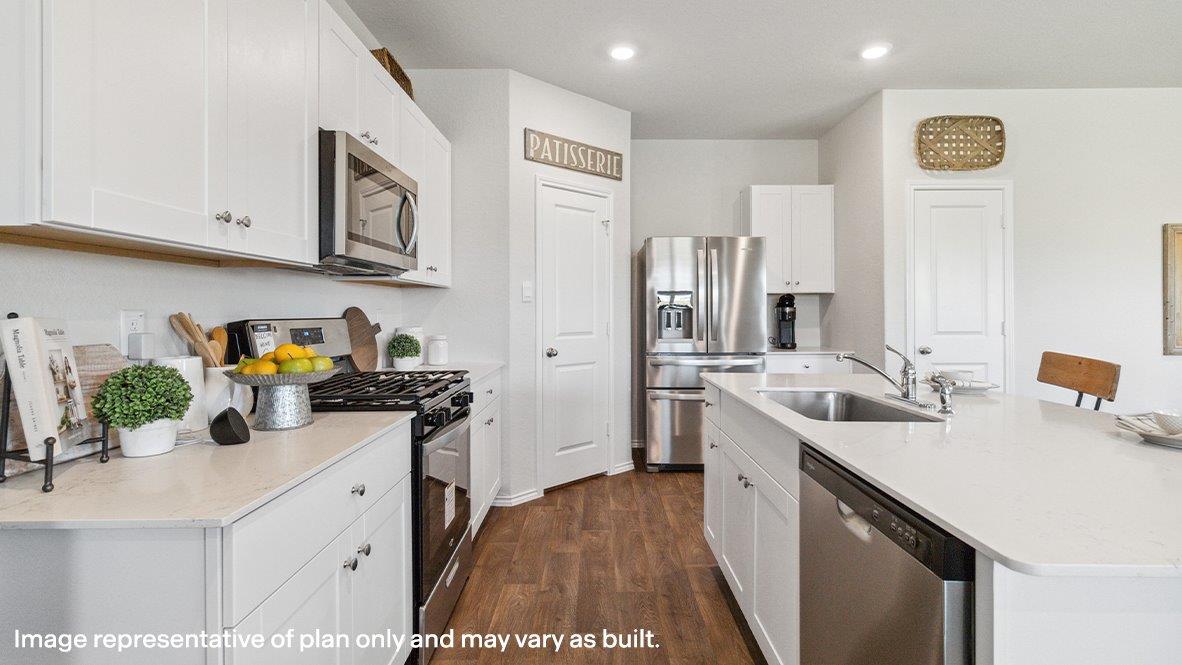 Open-concept kitchen with spacious corner pantry and plenty of cabinet space.