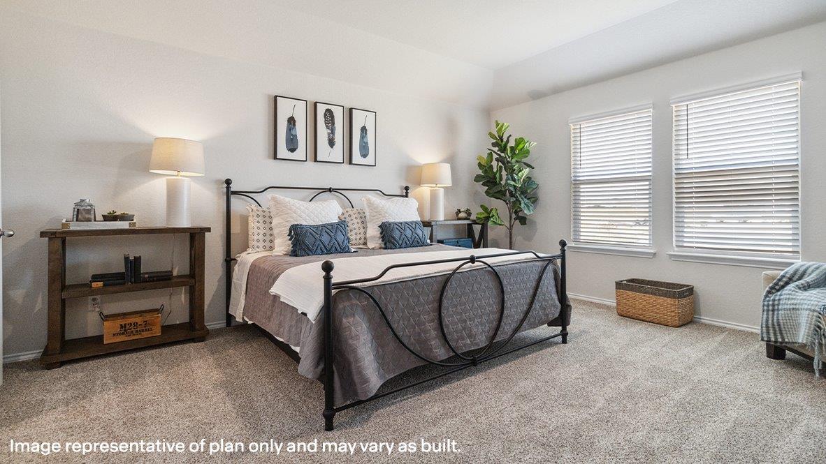 Spacious primary bedroom with quality carpet and ensuite bathroom.