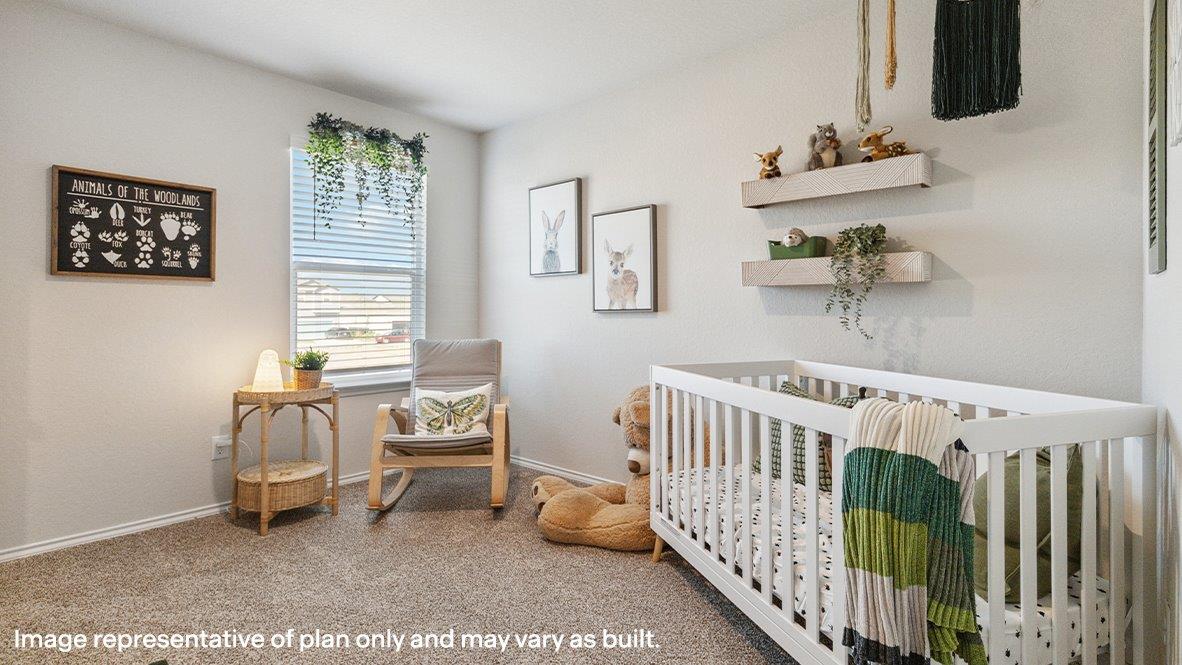 Second bedroom with large windows and carpet.
