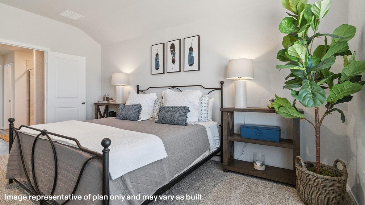 Primary bedroom with carpet and ensuite bathroom with spacious walk in shower.