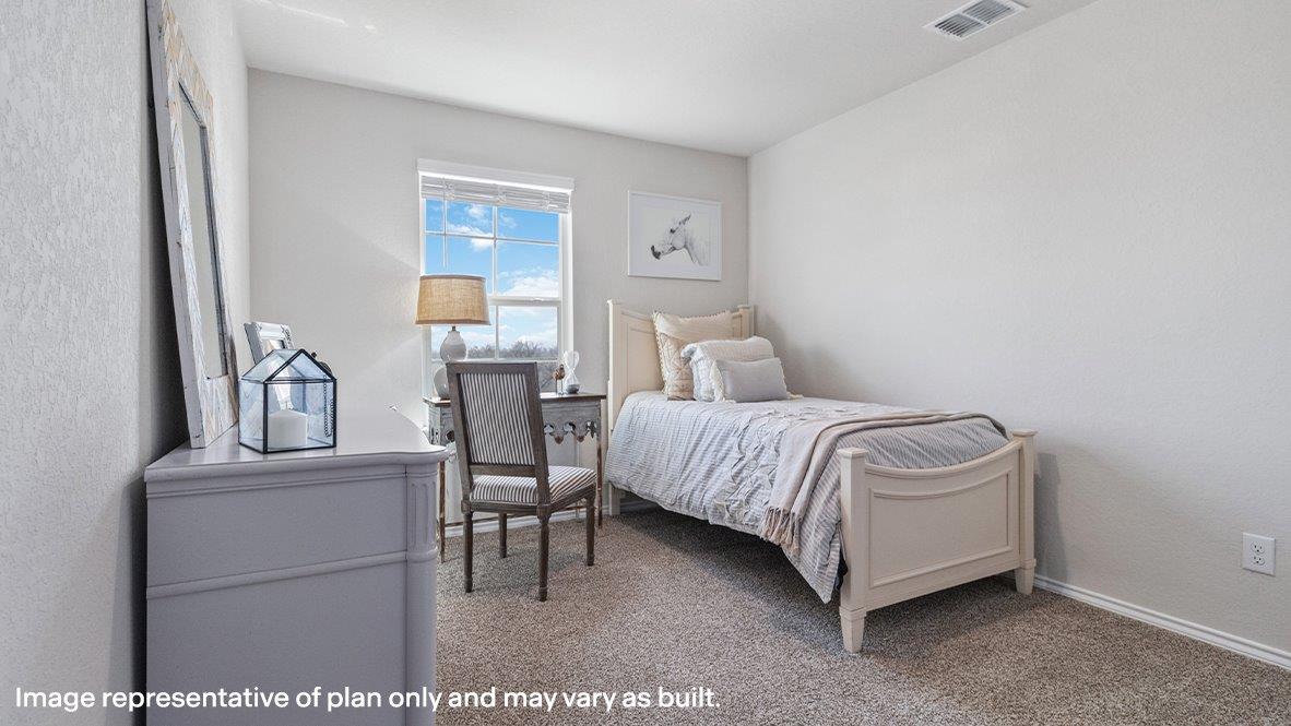 Fourth bedroom with carpet flooring and large window.