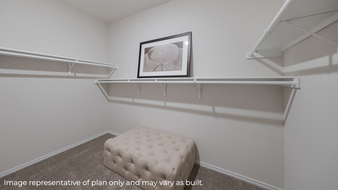Spacious primary bathroom closet with shelving.