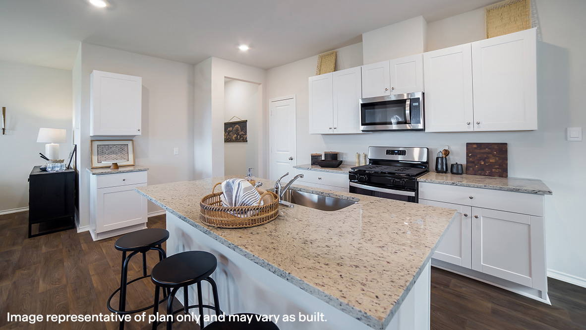Kitchen overlooking dining and living areas with windows providing plenty of natural light.