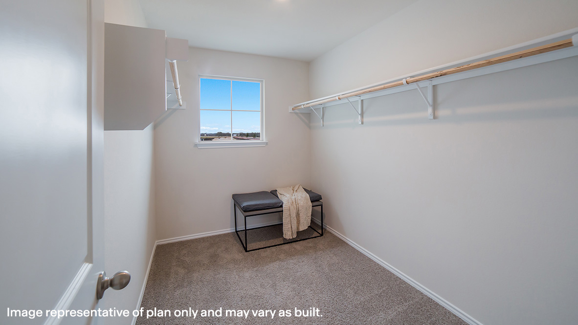 Oversized primary bedroom closet with shelving.