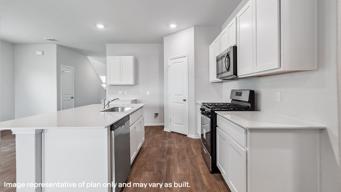 Open-concept kitchen with spacious corner pantry and plenty of cabinet space.