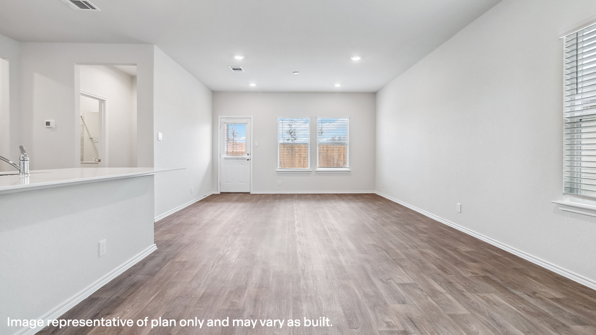 Open-concept living area with hard surface flooring and windows providing plenty of natural light.