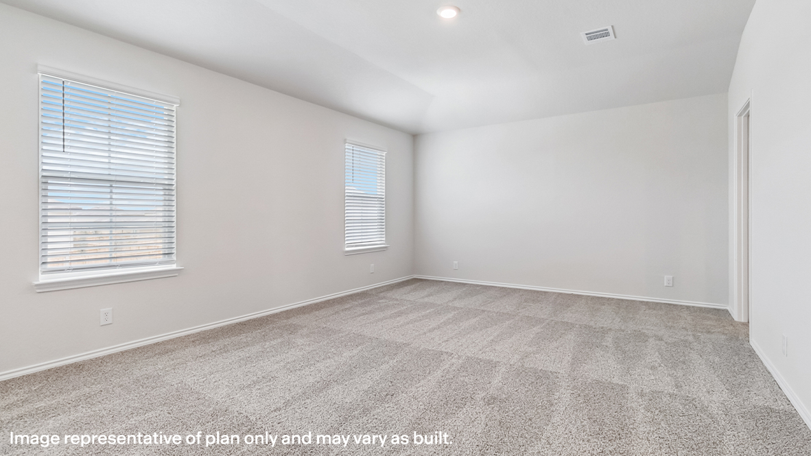 Spacious primary bedroom with ensuite bathroom and walk-in closet.