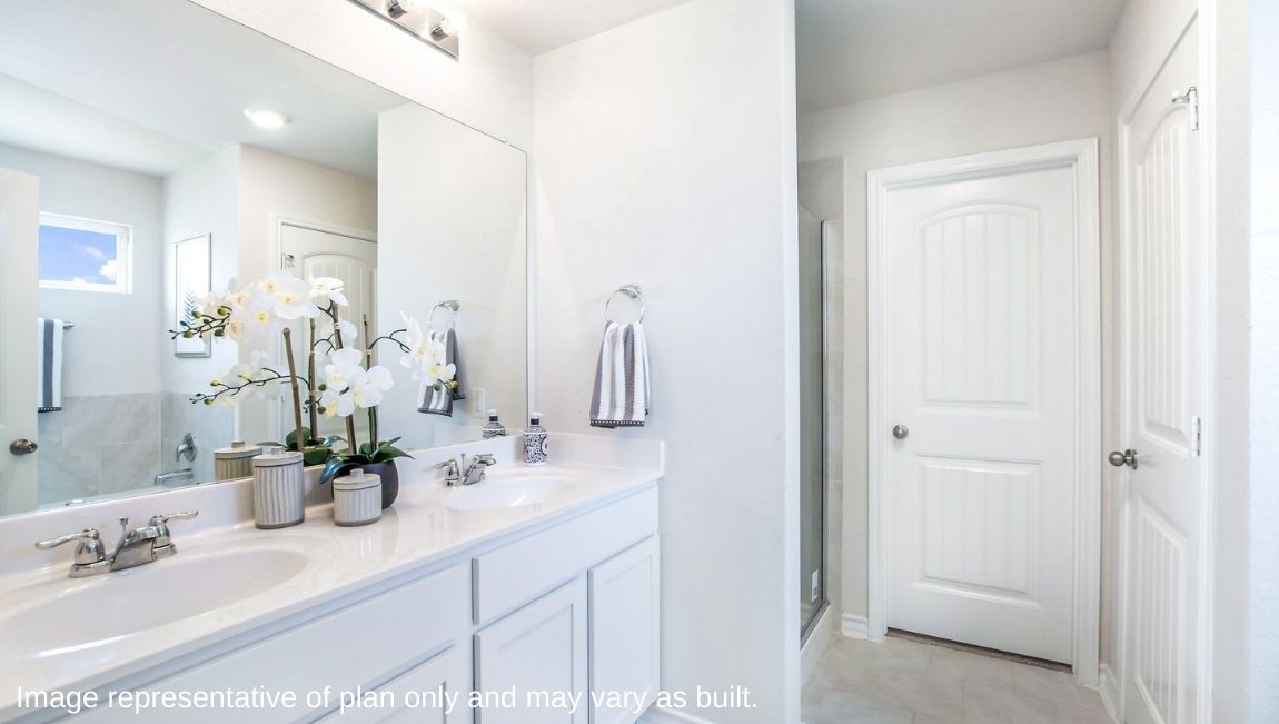 primary ensuite bathroom with dual vanity sinks