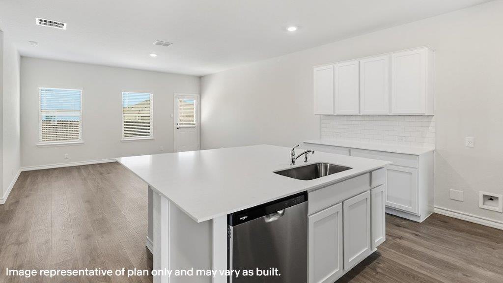 large kitchen island with quartz countertops overlooking living room