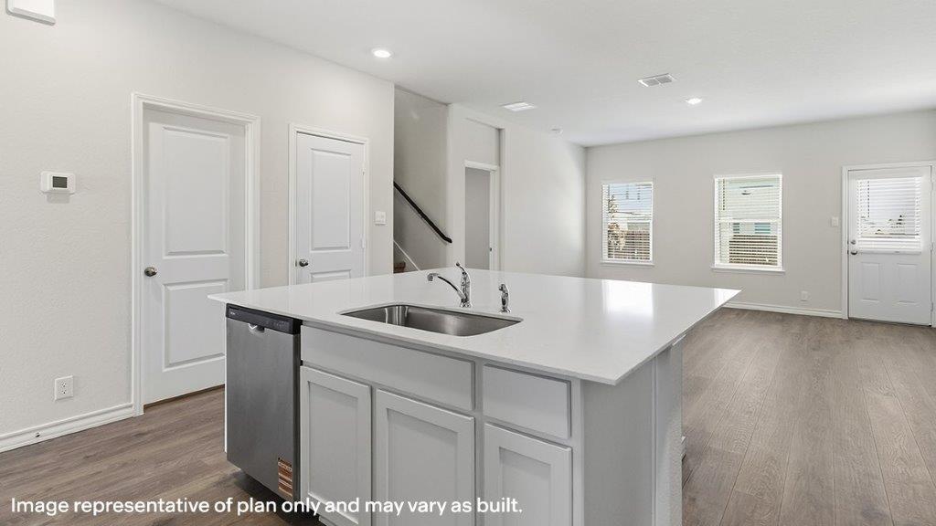 large kitchen island with quartz countertops overlooking living room