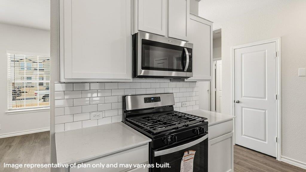 kitchen with stainless steel appliances and subway tile backsplash