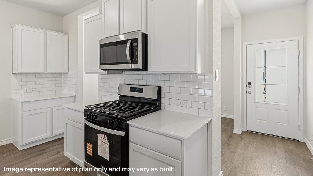 kitchen with stainless steel appliances and subway tile backsplash
