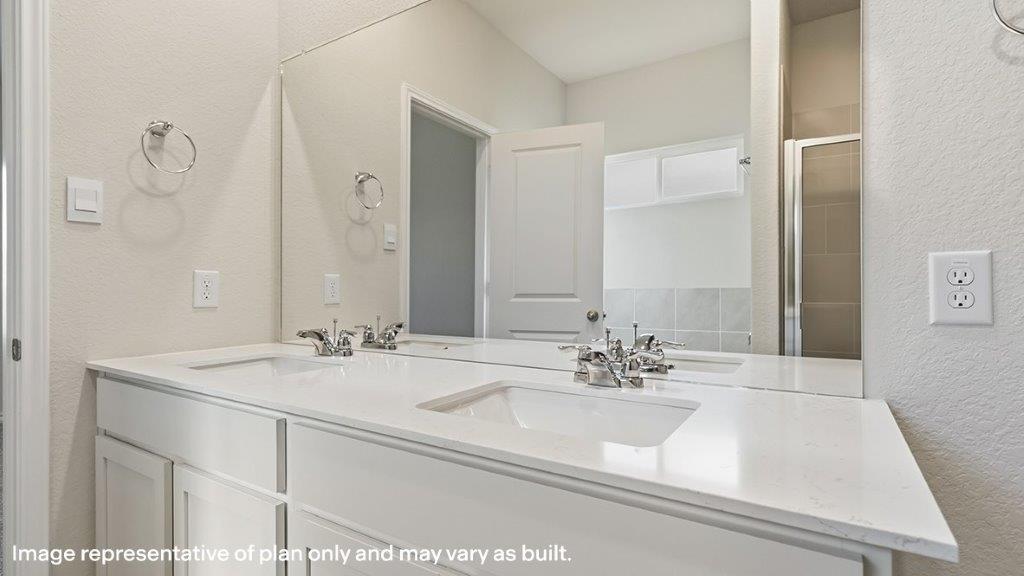 primary bathroom with dual vanity sinks