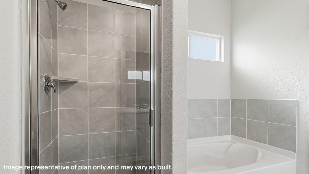 separate walk in shower and garden tub in primary bathroom