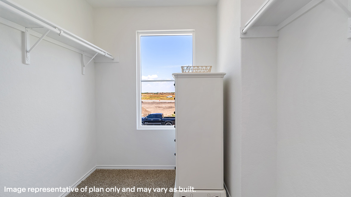 Primary suite walk-in closet in Stonehill new home with built-in shelving and generous storage