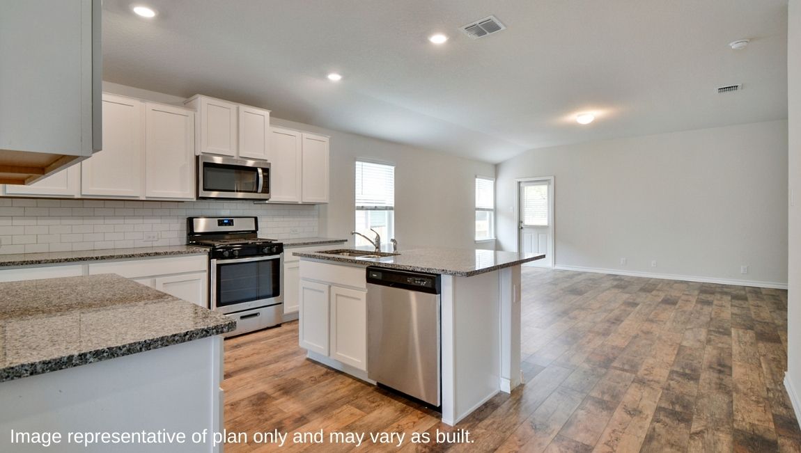Kitchen with island overlooking open concept living room with hard surface flooring.