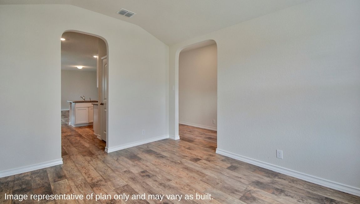 Entry way leading into spacious dining area with hard surface flooring.