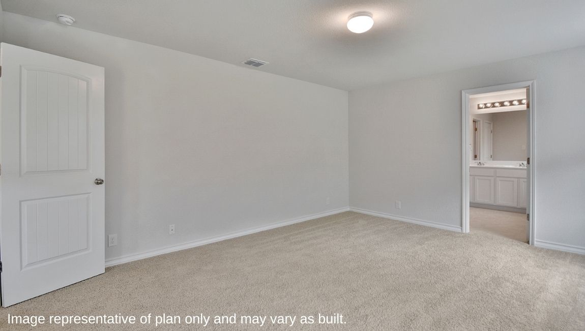 Spacious primary bedroom located at back of house featuring large ensuite bathroom.