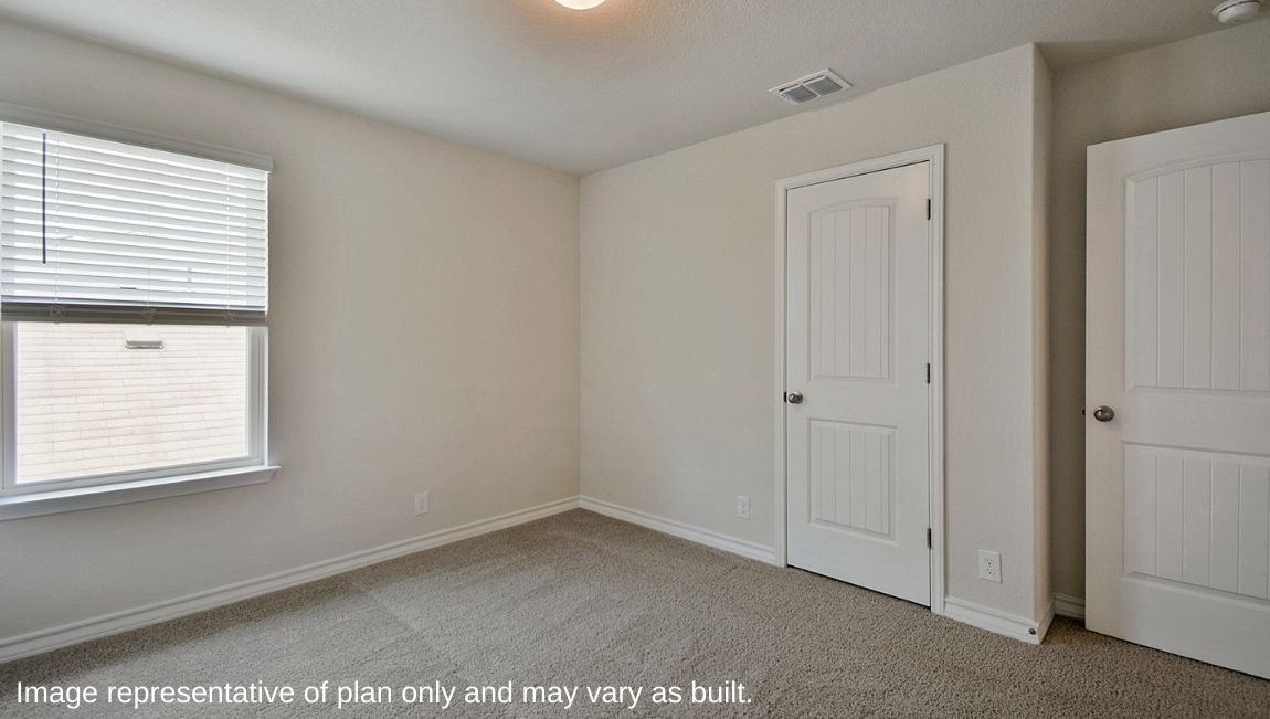 Secondary bedroom with quality carpet, window and closet.