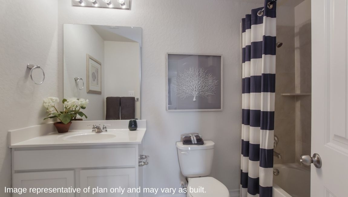 Second full bathroom with combined bathtub and shower, toilet and hard surface flooring.