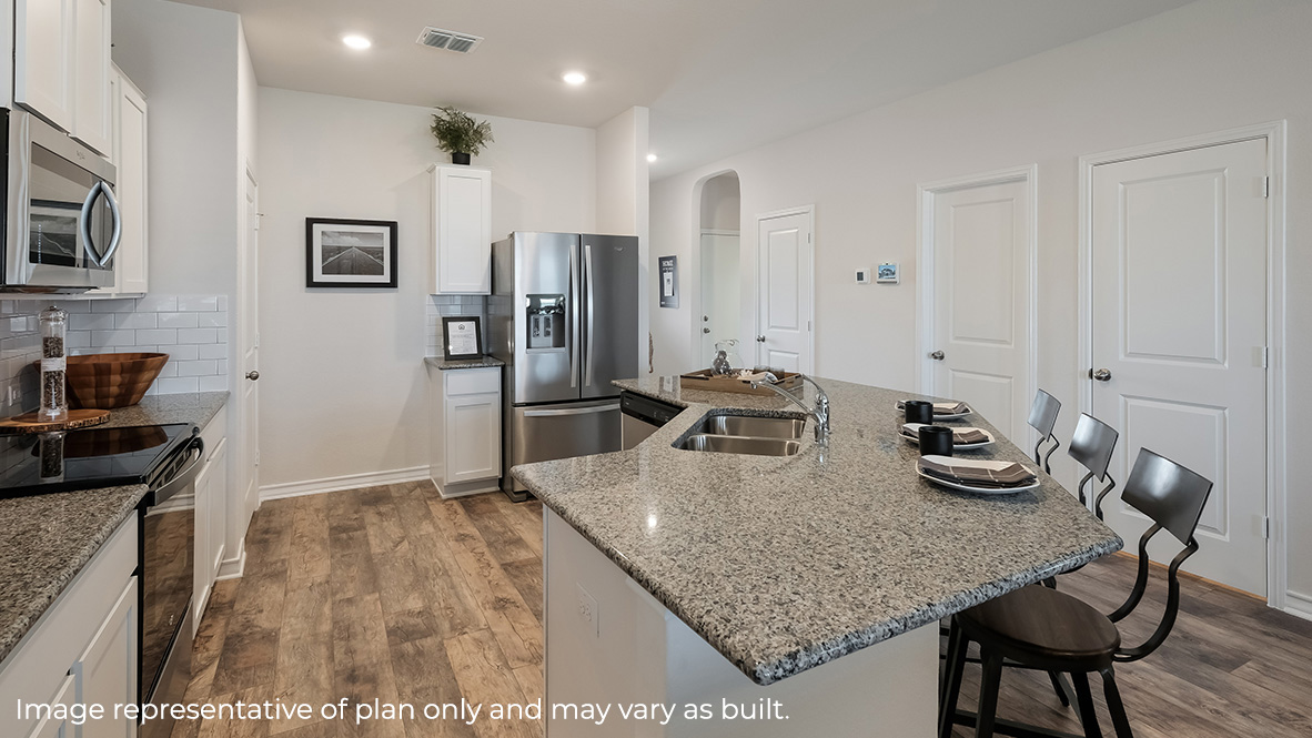 Large angled kitchen island facing spacious family room.