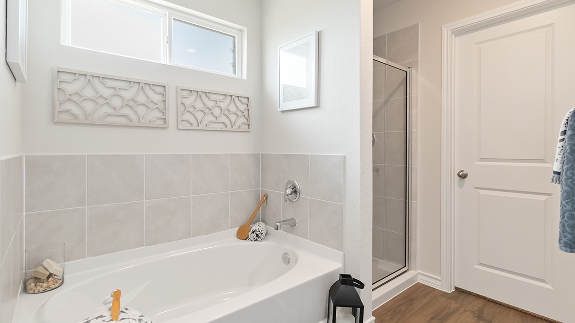 Primary ensuite bathroom with garden tub, walk in shower and walk in closet.