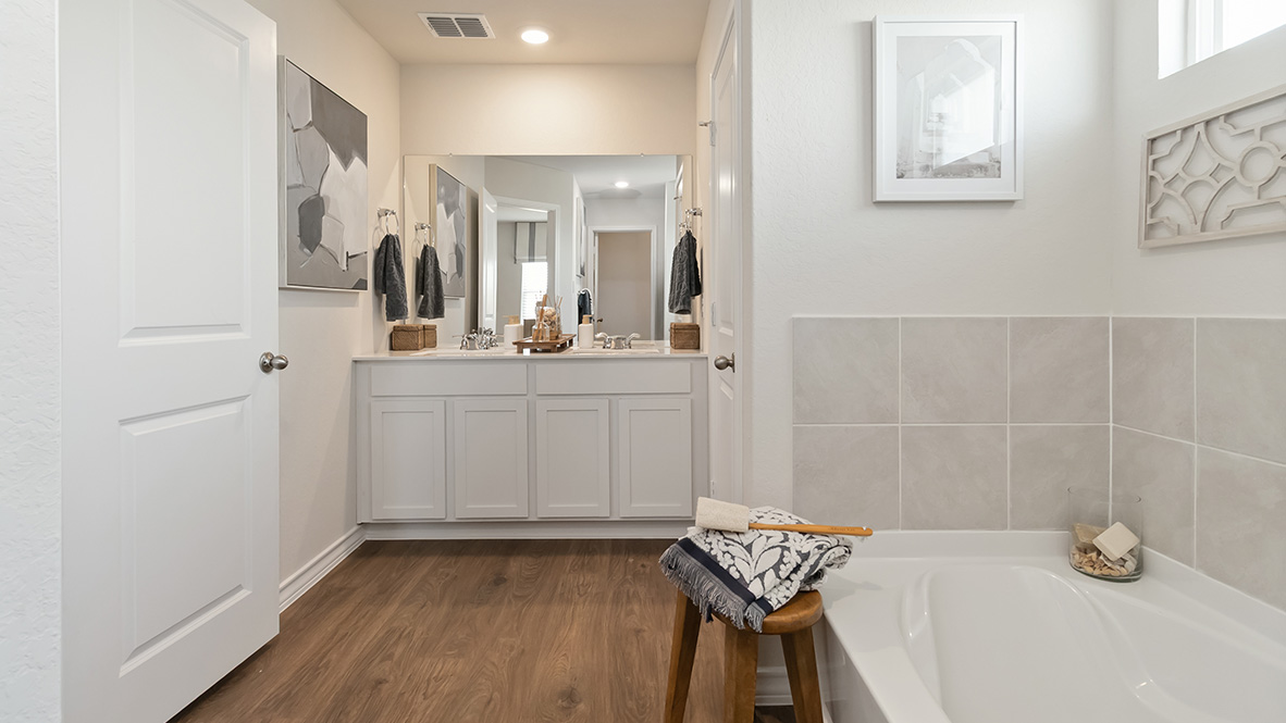 Primary ensuite bathroom with garden tub, walk in shower and walk in closet.