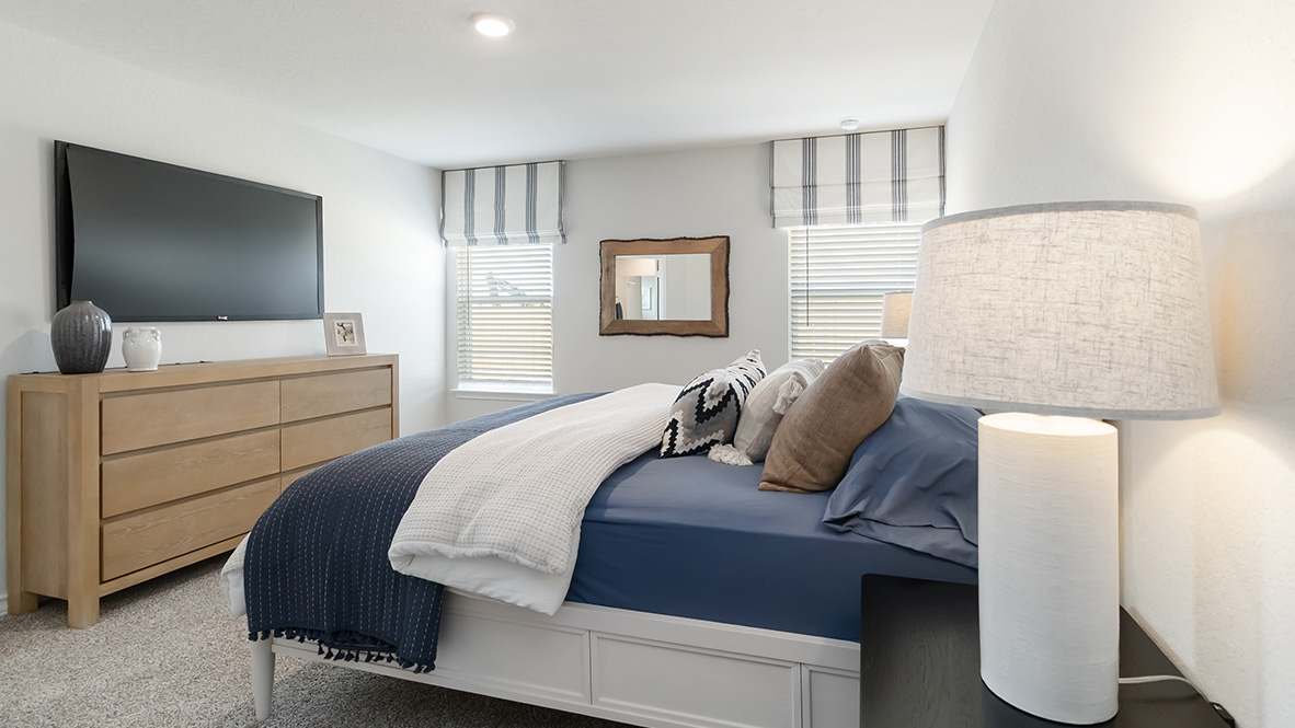 Primary bedroom with quality carpet and large window providing plenty of natural light