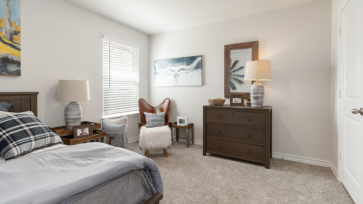 third bedroom with carpet flooring, large window and closet