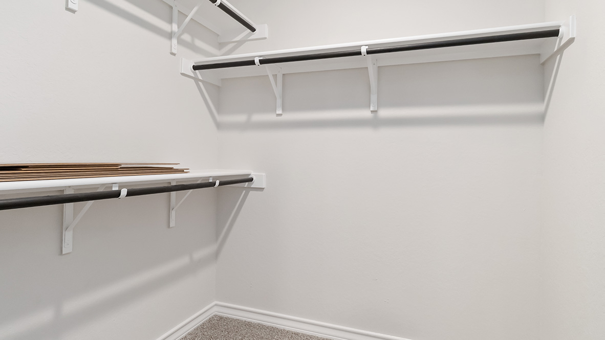 walk-in closet at primary ensuite bathroom with built in shelving