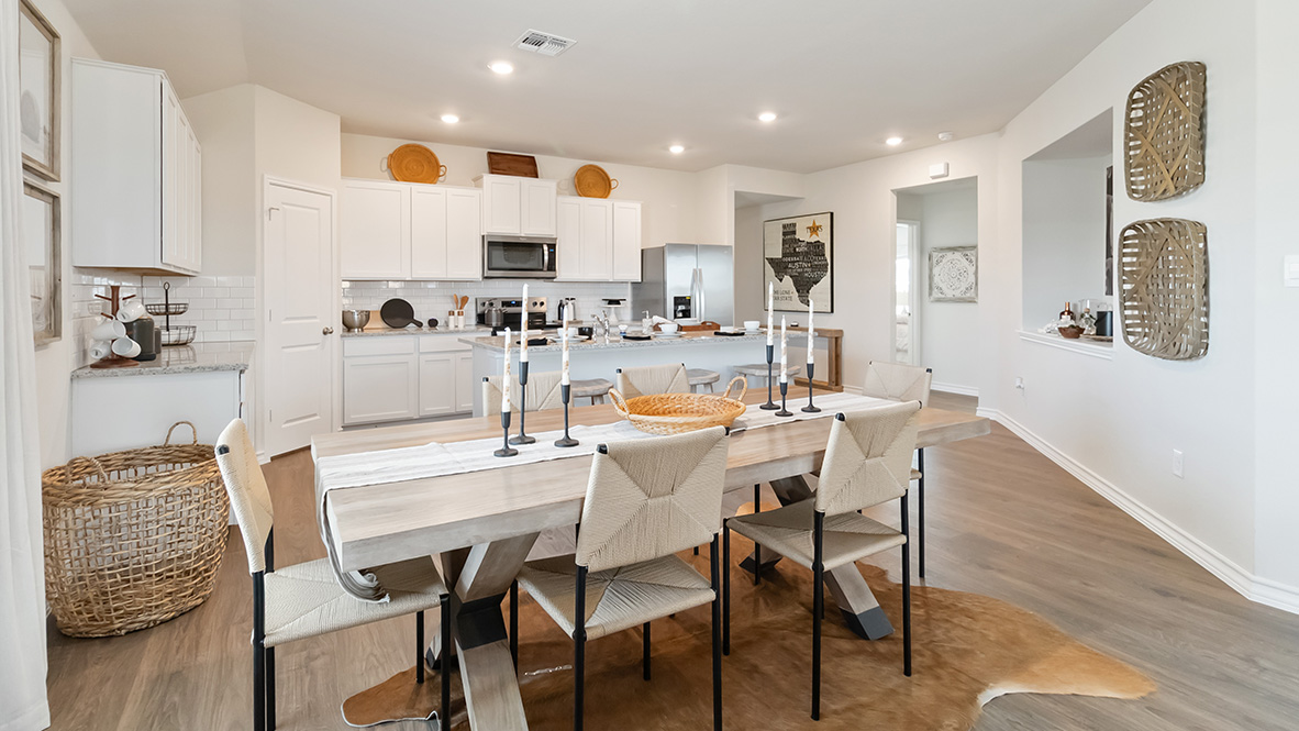 blended dining area and kitchen with hard surface flooring and large windows throughout